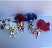 Bundles of red, white and blue novelty pens grouped by style