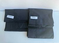 Four folded navy blue pillowcases side by side