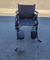 Front view showing seat, backrest, leg rests and footplates