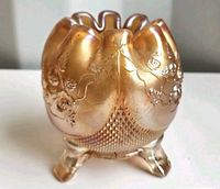 Front view of footed marigold carnival glass rose bowl