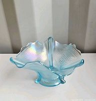 Top angle of blue carnival glass dish showing ribbed pattern and iridescence
