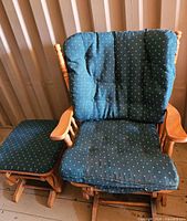 Wide wooden glider rocker with matching ottoman, cushions in place