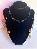 Choker displayed on bust with both earrings attached