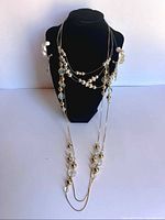 Full display of all jewelry on bust showing layering and length