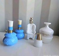All five Avon milk glass perfume bottles grouped
