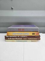 Stack of five books showing spines and covers