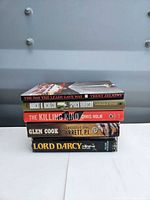 Front view of stacked paperbacks showing titles and spine conditions