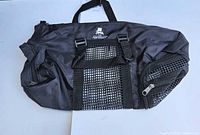 Full view of restraint bag showing overall condition, mesh panels, zippers, straps, handle and logo