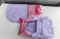 Both dog jackets laid flat showing colours and design