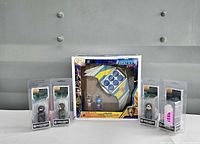 Front view showing boxed Milano set centered, with four blister-packed Pin Mate figures flanking