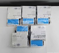 Five sealed Room Essentials packs laid out front view