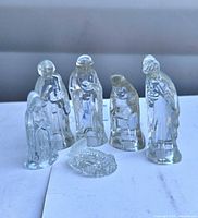 Front view of six clear glass nativity pieces