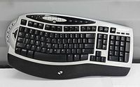 Front view showing full key layout, multimedia buttons and wrist rest