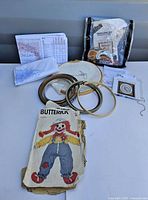 Overview of all items on table including charts, hoops, pattern, kit
