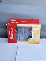 Front view of sealed Sunbeam 100-piece sewing kit box