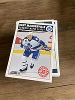 Stack of Score 92 Kent Manderville card visible
