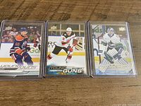Front view of three sleeved Upper Deck Young Guns cards showing Boeser, Butcher, Yamamoto