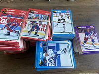Stacks of Score hockey cards with blue, red and purple borders bundled with elastics on tabletop
