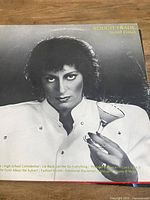 Front cover showing artist Carole Pope holding martini glass, album title and band name visible
