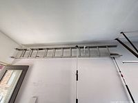 Full view of aluminum ladder mounted on wall
