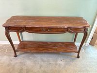 Full front view of console table showing drawer, legs and lower shelf
