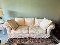Front view of ivory cream sofa with pillows