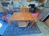 top view of dining table with four chairs around it