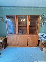 Front view of entire china cabinet showing glass display top and base with sliding doors