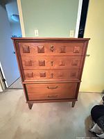 Full front view of walnut mid-century dresser on tapered legs