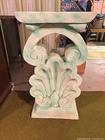 Side view showing full Corinthian scroll and acanthus design