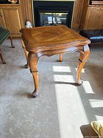 Full view of square French Provincial end table showing legs and overall form