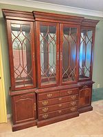 Front view showing entire china cabinet with glass doors, drawers, and lower cabinets