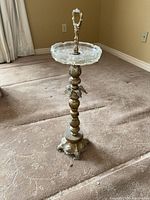 Full view of metal pedestal stand with glass tray and handle