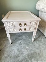 Front view of nightstand showing drawers, legs, hardware, finish