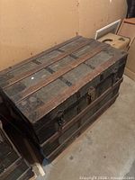 Overall view of first trunk showing metal strap construction and latch