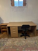 Overall view of desk, chair and bookshelf