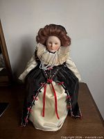 Front view of Franklin Mint Queen Elizabeth I porcelain doll showing complete attire and condition