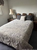 Full view of bed showing headboard and surrounding context