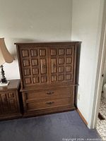 Front view of tallboy dresser showing cabinet doors and lower drawers