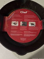 Top view of cast iron skillet with red cardboard insert