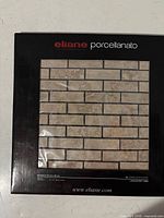 Front of package showing Eliane Porcellanato branding and tile sample