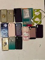 All fourteen phone cases laid out showing variety