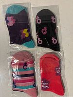 Assorted sealed pairs of socks showing colour variety