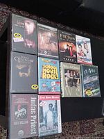 Front view of nine sealed DVDs arranged on table