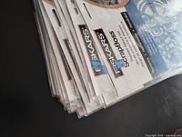 Stack of sealed Fiskars ScrapBoss stencil packages