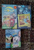 Front covers of Teletubbies, Blue’s Clues and Disney 101 Dalmatians sealed software boxes