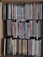 Top view of box showing two rows of CDs, many still in shrink-wrap