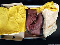 Pair of boots in original box with tissue paper