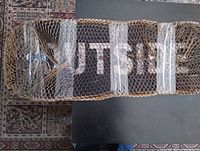 Full top view of snowboard wrapped in honeycomb cardboard and tape