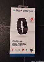 Front of sealed Fitbit Charge 2 retail box showing product image and features